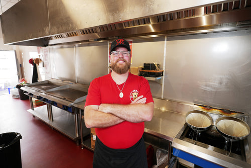 James from Jax burger shack standing in front of kitchen