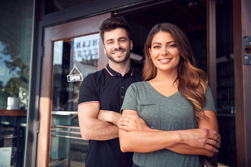 Cafe owners standing outside cafe