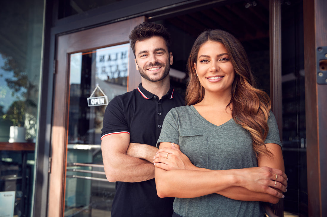 Cafe owners standing outside cafe